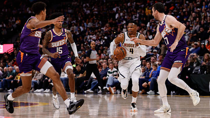 Oct 13, 2024; Denver, Colorado, USA; Denver Nuggets guard Russell Westbrook (4) controls the ball under pressure from Phoenix Suns forward Frank Kaminsky (47) and forward Jalen Bridges (15) and center Oso Ighodaro (4) in the third quarter at Ball Arena. Mandatory Credit: Isaiah J. Downing-Imagn Images Oct 13, 2024; Denver, Colorado, USA; Denver Nuggets guard Russell Westbrook (4) controls the ball under pressure from Phoenix Suns forward Frank Kaminsky (47) and forward Jalen Bridges (15) and center Oso Ighodaro (4) in the third quarter at Ball Arena. Mandatory Credit: Isaiah J. Downing-Imagn Images