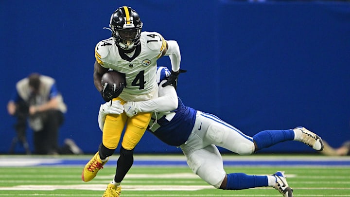 Sep 29, 2024; Indianapolis, Indiana, USA; Pittsburgh Steelers wide receiver George Pickens (14) is tackled by Indianapolis Colts linebacker Zaire Franklin (44) during the second quarter at Lucas Oil Stadium. Mandatory Credit: Marc Lebryk-Imagn Images