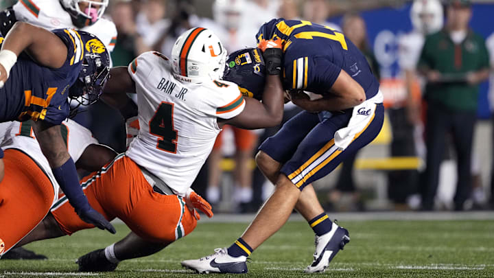 Oct 5, 2024; Berkeley, California, USA; Miami Hurricanes defensive lineman Rueben Bain Jr. (4) sacks California Golden Bears quarterback Fernando Mendoza (right) during the fourth quarter at California Memorial Stadium. Mandatory Credit: Darren Yamashita-Imagn Images