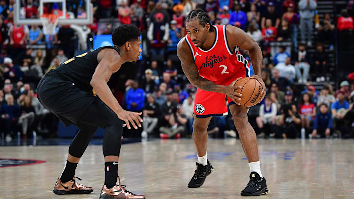 Mar 18, 2025; Inglewood, California, USA; Los Angeles Clippers forward Kawhi Leonard (2) controls the ball against Cleveland Cavaliers forward De'Andre Hunter (12) during the second half at Intuit Dome. Mandatory Credit: Gary A. Vasquez-Imagn Images
