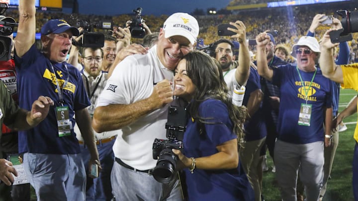 Sep 13, 2025; Morgantown, West Virginia, USA; West Virginia Mountaineers head coach Rich Rodriguez celebrates with his daughter Raquel after defeating the Pittsburgh Panthers at Milan Puskar Stadium. Mandatory Credit: Ben Queen-Imagn Images