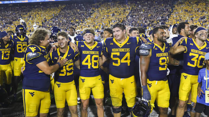 Sep 13, 2025; Morgantown, West Virginia, USA; West Virginia Mountaineers players celebrate after defeating the Pittsburgh Panthers at Milan Puskar Stadium. Mandatory Credit: Ben Queen-Imagn Images Sep 13, 2025; Morgantown, West Virginia, USA; West Virginia Mountaineers players celebrate after defeating the Pittsburgh Panthers at Milan Puskar Stadium. Mandatory Credit: Ben Queen-Imagn Images