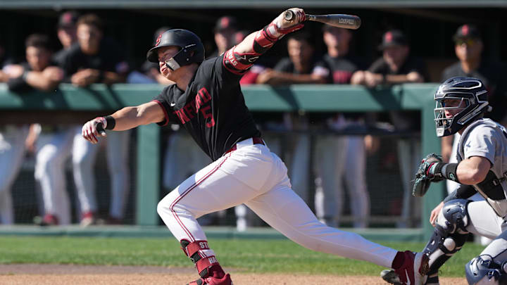 Mar 1, 2025; Stanford, CA, USA; Stanford Cardinal third baseman Trevor Haskins (5) hits a single against the Xavier Musketeers during the first inning at Sunken Diamond. Mandatory Credit: Darren Yamashita-Imagn Images