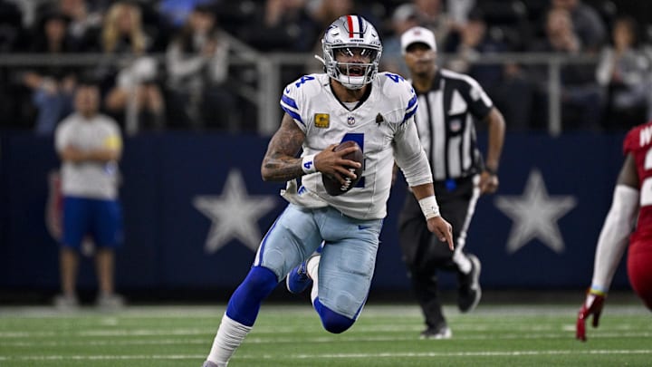 Dallas Cowboys quarterback Dak Prescott runs with the ball during the game between the Cowboys and the Arizona Cardinals.