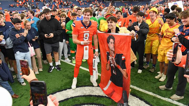 Oct 31, 2026; Syracuse, New York, USA; Syracuse Orange quarterback Steve Angeli (9) posses for a photo with a fan following the game against the Southern Methodist University Mustangs at the JMA Wireless Dome. Mandatory Credit: Rich Barnes-Imagn Images Oct 31, 2026; Syracuse, New York, USA; Syracuse Orange quarterback Steve Angeli (9) posses for a photo with a fan following the game against the Southern Methodist University Mustangs at the JMA Wireless Dome. Mandatory Credit: Rich Barnes-Imagn Images