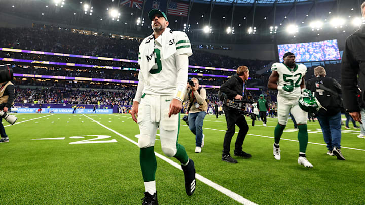 Oct 6, 2024; Tottenham, ENG; A dejected New York Jets quarterback Aaron Rodgers (8) walks back to the locker room after the 17-23 defeat to the Minnesota Vikings at Tottenham Hotspur Stadium. 