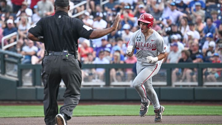 Jun 18, 2025; Omaha, Neb, USA;  Arkansas Razorbacks catcher Ryder Helfrick (27) circles the bases after hitting a home run against the LSU Tigers during the fourth inning at Charles Schwab Field. Mandatory Credit: Steven Branscombe-Imagn Images