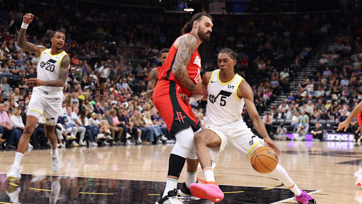 Oct 7, 2024; Salt Lake City, Utah, USA; Utah Jazz forward Cody Williams (5) dribbles against Houston Rockets center Steven Adams (12) during the second quarter at Delta Center. Mandatory Credit: Rob Gray-Imagn Images