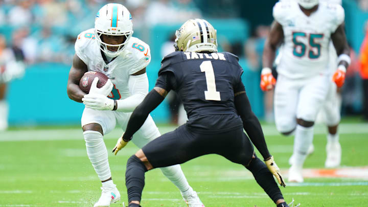 Nov 30, 2025; Miami Gardens, Florida, USA; Miami Dolphins wide receiver Malik Washington (6) runs after the catch as New Orleans Saints cornerback Alontae Taylor (1) defends during the first half at Hard Rock Stadium. Mandatory Credit: Rich Storry-Imagn Images Nov 30, 2025; Miami Gardens, Florida, USA; Miami Dolphins wide receiver Malik Washington (6) runs after the catch as New Orleans Saints cornerback Alontae Taylor (1) defends during the first half at Hard Rock Stadium. Mandatory Credit: Rich Storry-Imagn Images