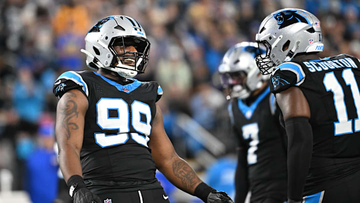 Carolina Panthers defensive tackle Tershawn Wharton (99) reacts with linebacker Nic Scourton 