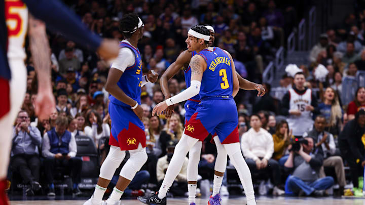Apr 6, 2024; Denver, Colorado, USA; Denver Nuggets guard Reggie Jackson (7), forward Justin Holiday (9) and guard Julian Strawther (3) celebrate after a three-point shot against the Atlanta Hawks in the first half at Ball Arena. Mandatory Credit: Michael Ciaglo-USA TODAY Sports