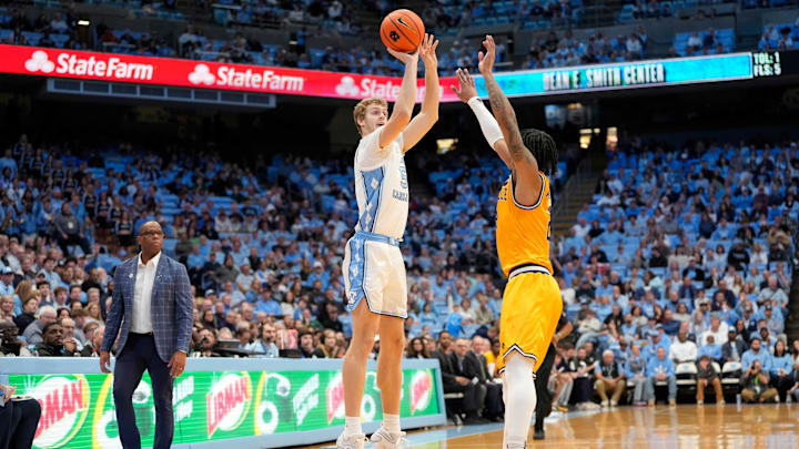 Dec 14, 2024; Chapel Hill, North Carolina, USA; North Carolina Tar Heels guard Cade Tyson (5) shoots a three point shot as La Salle Explorers guard Corey McKeithan (2) defends in the second half at Dean E. Smith Center. Mandatory Credit: Bob Donnan-Imagn Images