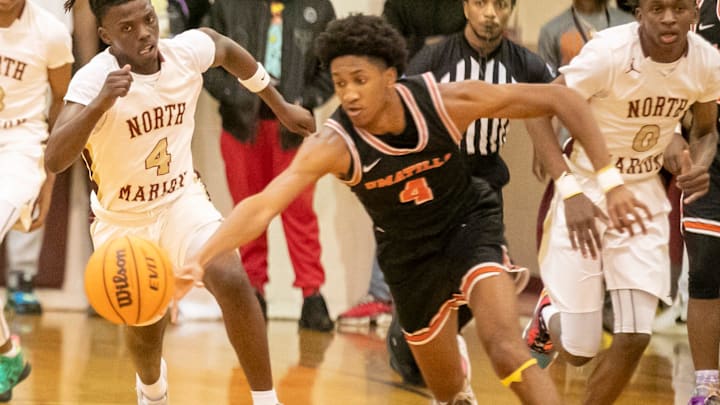 North Marion High School guard Titus Williams (4) tries to catch Umatila guard Herly Brutus (4) as North Marion takes on Umatilla during the 2023 4A FHSAA Boys Basketball State Tournament  Thursday, Feb. 16, 2023, at North Marion High School in Citra, Fla. North Marion won 74-37.[Alan Youngblood/Ocala Star-Banner]

Oca Nm Vs Umatilla 00724963