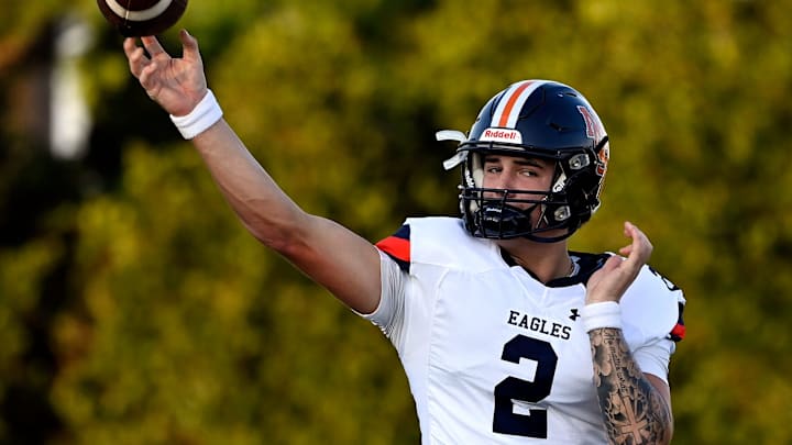 Nashville Christian quarterback Jared Curtis (2) passes as he warms up before an high school football scrimmage against Franklin Road Academy Friday, Aug. 16, 2024, in Nashville, Tenn.