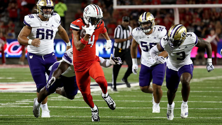 Sep 30, 2023; Tucson, Arizona, USA; Arizona Wildcats wide receiver Tetairoa McMillan (4) makes a catch for a first down against Washington Huskies defensive lineman Ulumoo Ale (68), defensive end Voi Tunuufi (52), and safety Mishael Powell (3)  in the first half at Arizona Stadium. Mandatory Credit: Zachary BonDurant-USA TODAY Sports