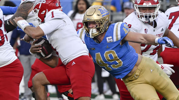 Nov 30, 2024; Pasadena, California, USA; UCLA Bruins linebacker Carson Schwesinger (49) sacks Fresno State Bulldogs quarterback Mikey Keene (1) during the second quarter at Rose Bowl. Mandatory Credit: Robert Hanashiro-Imagn Images