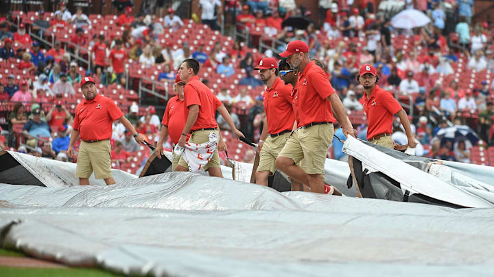 Sep 4, 2022; St. Louis, Missouri, USA; Grounds crew putting the tarp on the field during a rain delay prior to a game between the St. Louis Cardinals and the Chicago Cubs at Busch Stadium. Mandatory Credit: Joe Puetz-Imagn Images