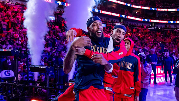 Oct 23, 2024; New Orleans, Louisiana, USA;  New Orleans Pelicans guard Jose Alvarado (15) jumps on forward Brandon Ingram (14) as he is announced to the fans to start the game against the Chicago Bulls at Smoothie King Center.