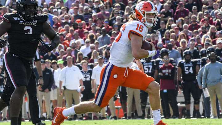 Clemson quarterback Trevor Lawrence (16) runs for a first down year South Carolina defensive tackle Javon Kinlaw(3) during the first quarter at Williams-Brice Stadium in Columbia, South Carolina Saturday, November 30, 2019.