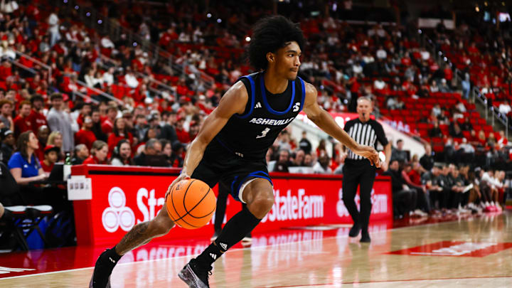 Dec 6, 2025; Raleigh, North Carolina, USA; UNC Asheville Bulldogs guard Kameron Taylor (3) dribbles the ball during the second half of the game against NC State Wolfpack at Lenovo Center. Mandatory Credit: Jaylynn Nash-Imagn Images