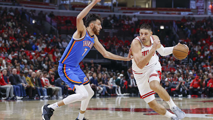 Oct 26, 2024; Chicago, Illinois, USA; Chicago Bulls center Nikola Vucevic (9) drives to the basket against Oklahoma City Thunder forward Chet Holmgren (7) during the first half at United Center. Mandatory Credit: Kamil Krzaczynski-Imagn Images Oct 26, 2024; Chicago, Illinois, USA; Chicago Bulls center Nikola Vucevic (9) drives to the basket against Oklahoma City Thunder forward Chet Holmgren (7) during the first half at United Center. Mandatory Credit: Kamil Krzaczynski-Imagn Images