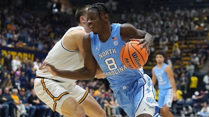 Jan 17, 2026; Berkeley, California, USA; North Carolina Tar Heels forward Caleb Wilson (8) dribbles against California Golden Bears forward John Camden (left) during the first half at Haas Pavilion. Mandatory Credit: Darren Yamashita-Imagn Images