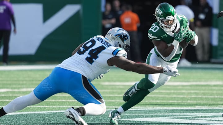 Oct 19, 2025; East Rutherford, New Jersey, USA; New York Jets running back Breece Hall (20) runs with the ball while being defended by Carolina Panthers defensive end A'Shawn Robinson (94) in the third quarter at MetLife Stadium. Mandatory Credit: Robert Deutsch-Imagn Images