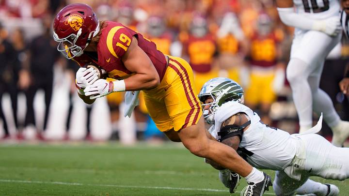 Oregon defensive back Aaron Flowers brings down USC tight end Mark Bowman as the Oregon Ducks face the USC Trojans on Sept. 26, 2026, at Los Angeles Memorial Coliseum in Los Angeles, California.