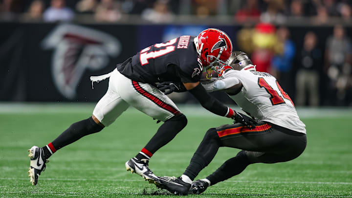 Oct 3, 2024; Atlanta, Georgia, USA; Atlanta Falcons safety Justin Simmons (31) tackles Tampa Bay Buccaneers wide receiver Chris Godwin (14) in the first quarter at Mercedes-Benz Stadium. Mandatory Credit: Brett Davis-Imagn Images
