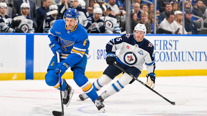 Apr 9, 2026; St. Louis, Missouri, USA; St. Louis Blues defenseman Philip Broberg (6) controls the puck as Winnipeg Jets left wing Cole Koepke (45) defends during the second period at Enterprise Center. Mandatory Credit: Jeff Curry-Imagn Images