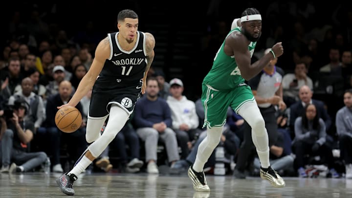 Nov 18, 2025; Brooklyn, New York, USA; Brooklyn Nets forward Michael Porter Jr. (17) brings the ball up court against Boston Celtics center Neemias Queta (88) during the fourth quarter at Barclays Center. Mandatory Credit: Brad Penner-Imagn Images