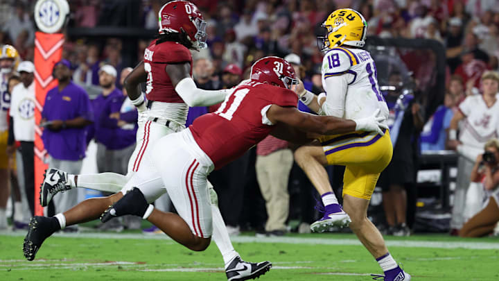 Nov 8, 2025; Tuscaloosa, Alabama, USA; Louisiana State Tigers quarterback Garrett Nussmeier (18) under pressure from Alabama Crimson Tide linebacker Deontae Lawson (0) and defensive lineman Keon Keeley (31) during the second quarter of the game at Saban Field at Bryant-Denny Stadium. Mandatory Credit: David Leong-Imagn Images Nov 8, 2025; Tuscaloosa, Alabama, USA; Louisiana State Tigers quarterback Garrett Nussmeier (18) under pressure from Alabama Crimson Tide linebacker Deontae Lawson (0) and defensive lineman Keon Keeley (31) during the second quarter of the game at Saban Field at Bryant-Denny Stadium. Mandatory Credit: David Leong-Imagn Images