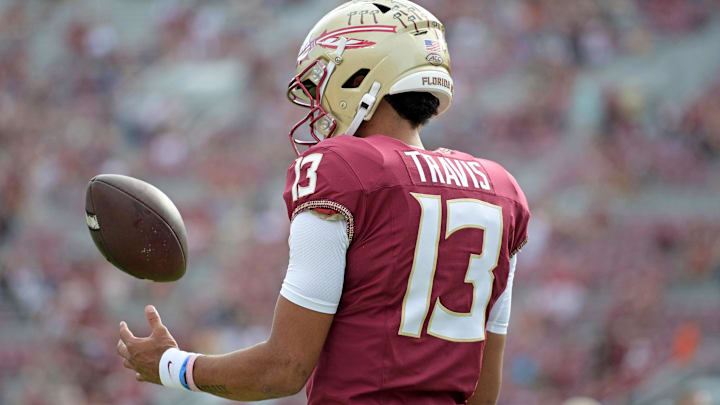 Nov 11, 2023; Tallahassee, Florida, USA; Florida State Seminoles quarterback Jordan Travis (13) takes a moment to himself before the game against the Miami Hurricanes at Doak S. Campbell Stadium. Mandatory Credit: Melina Myers-Imagn Images Nov 11, 2023; Tallahassee, Florida, USA; Florida State Seminoles quarterback Jordan Travis (13) takes a moment to himself before the game against the Miami Hurricanes at Doak S. Campbell Stadium. Mandatory Credit: Melina Myers-Imagn Images