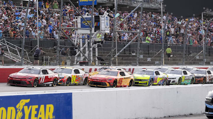 Apr 6, 2025; Darlington, South Carolina, USA; NASCAR Cup Series driver Denny Hamlin (11) leads the restart over driver Tyler Reddick (45) during the Goodyear 400 at Darlington Raceway. Apr 6, 2025; Darlington, South Carolina, USA; NASCAR Cup Series driver Denny Hamlin (11) leads the restart over driver Tyler Reddick (45) during the Goodyear 400 at Darlington Raceway.