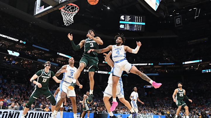 March 23, 2024, Charlotte, NC, USA; Michigan State Spartans guard Jaden Akins (3) and North Carolina Tar Heels guard RJ Davis (4) battle for a rebound in the second round of the 2024 NCAA Tournament at the Spectrum Center. Mandatory Credit: Bob Donnan-Imagn Images