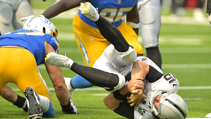 Sep 8, 2024; Inglewood, California, USA; Las Vegas Raiders quarterback Gardner Minshew (15) is sacked by Los Angeles Chargers linebacker Joey Bosa (97) in the second half at SoFi Stadium. Mandatory Credit: Jayne Kamin-Oncea-Imagn Images