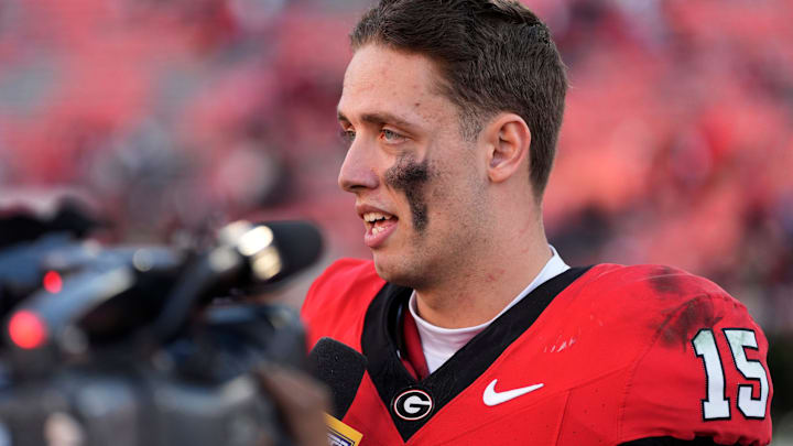 Georgia quarterback Carson Beck (15) speaks with the media after a NCAA college football game against Massachusetts.