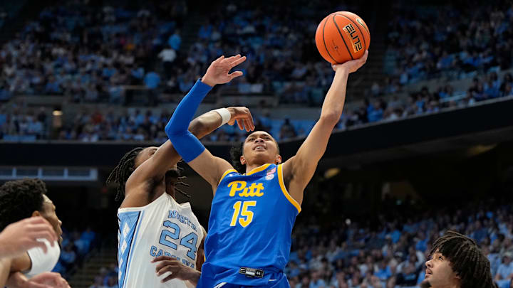 Feb 8, 2025; Chapel Hill, North Carolina, USA;  Pittsburgh Panthers guard Jaland Lowe (15) shoots as North Carolina Tar Heels forward Jae'Lyn Withers (24) defends in the first half at Dean E. Smith Center. Mandatory Credit: Bob Donnan-Imagn Images