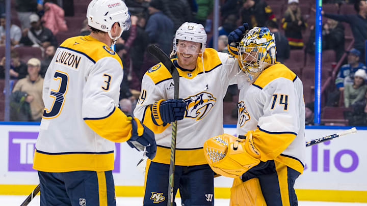 Nov 17, 2024; Vancouver, British Columbia, CAN; Nashville Predators defenseman Jeremy Lauzon (3) and forward Gustav Nyquist (14) and goalie Juuse Saros (74) celebrate the victory against the Vancouver Canucks at Rogers Arena. Mandatory Credit: Bob Frid-Imagn Images