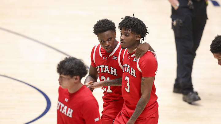 Utah Runnin' Utes guards Obomate Abbey (21) and Don McHenry (3) celebrate after defeating the West Virginia Mountaineers at Hope Coliseum.