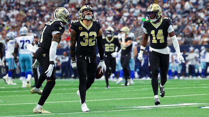 Sep 15, 2024; Arlington, Texas, USA; New Orleans Saints safety Tyrann Mathieu (32) celebrates with New Orleans Saints cornerback Alontae Taylor (1) and New Orleans Saints cornerback Kool-Aid McInstry(14) after making an interception during the second half against the Dallas Cowboys at AT&T Stadium. Mandatory Credit: Kevin Jairaj-Imagn Images