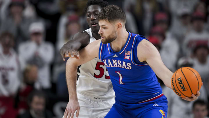 Jan 11, 2025; Cincinnati, Ohio, USA; Kansas Jayhawks center Hunter Dickinson (1) dribbles the ball against Cincinnati Bearcats forward Aziz Bandaogo (55) in the first half at Fifth Third Arena. Mandatory Credit: Aaron Doster-Imagn Images Jan 11, 2025; Cincinnati, Ohio, USA; Kansas Jayhawks center Hunter Dickinson (1) dribbles the ball against Cincinnati Bearcats forward Aziz Bandaogo (55) in the first half at Fifth Third Arena. Mandatory Credit: Aaron Doster-Imagn Images