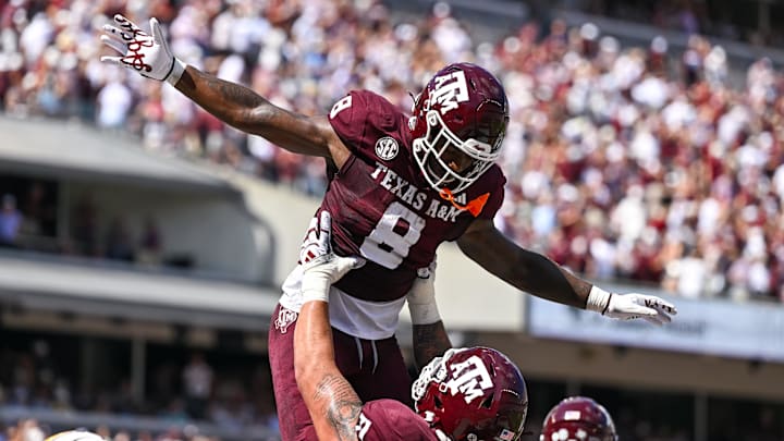 Oct 5, 2024; College Station, Texas, USA; Texas A&M Aggies running back Le'Veon Moss (8) celebrates with offensive lineman Chase Bisontis (71) after scoring a touchdown in the second quarter against the Missouri Tigers at Kyle Field. Mandatory Credit: Maria Lysaker-Imagn Images. 
