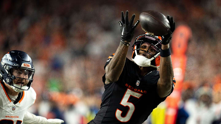 Cincinnati Bengals wide receiver Tee Higgins (5) catches a pass inside the 5-yard line as Denver Broncos cornerback Riley Moss (21) defends in overtime of the NFL game at Paycor Stadium in Cincinnati on Saturday, Dec. 28, 2024. Cincinnati Bengals wide receiver Tee Higgins (5) catches a pass inside the 5-yard line as Denver Broncos cornerback Riley Moss (21) defends in overtime of the NFL game at Paycor Stadium in Cincinnati on Saturday, Dec. 28, 2024.