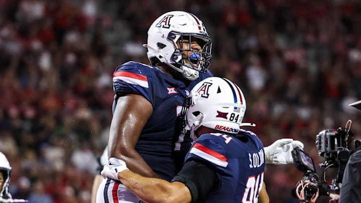 Aug 30, 2025; Tucson, Arizona, USA; Arizona Wildcats offensive lineman Michael Wooten (77) celebrates with tight end Sam Olson (84) during the third quarter of the game against the Hawaii Rainbow Warriors at Arizona Stadium. Mandatory Credit: Aryanna Frank-Imagn Images