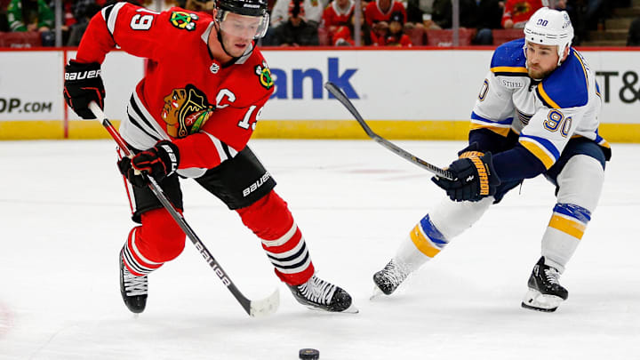 Sep 27, 2022; Chicago, Illinois, USA; Chicago Blackhawks center Jonathan Toews (19) controls the puck while defended by St. Louis Blues center Ryan O'Reilly (90) during the second period at United Center. Mandatory Credit: Jon Durr-Imagn Images