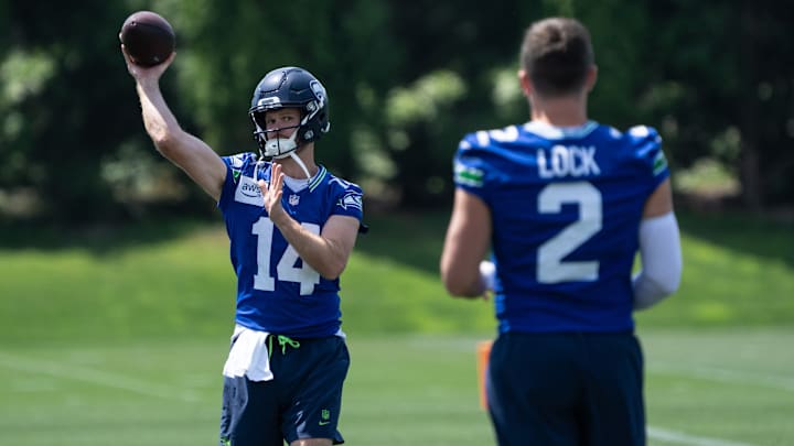 Jun 11, 2025; Renton, WA, USA; Seattle Seahawks quarterback Sam Darnold (14) passes the ball to quarterback Drew Lock (2) during mini-camp at Virginia Mason Athletic Center. 