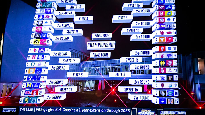 The 2022 bracket for women's basketball teams is seen on a television screen at a NCAA Tournament.