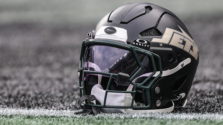 Dec 7, 2025; East Rutherford, New Jersey, USA; A general view of a Gotham City football rivalries helmet resting on the field before the game against the Miami Dolphins at MetLife Stadium. Mandatory Credit: Vincent Carchietta-Imagn Images
