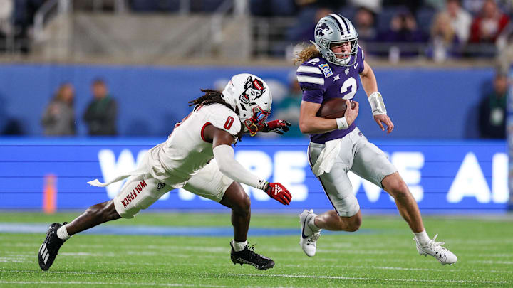 Dec 28, 2023; Orlando, FL, USA;  Kansas State Wildcats quarterback Avery Johnson (2) runs with the ball in the Pop-Tarts Bowl against the NC State Wolfpack.